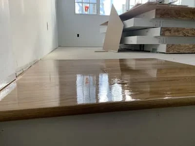 Newly installed and finished hardwood flooring with glossy polyurethane coating